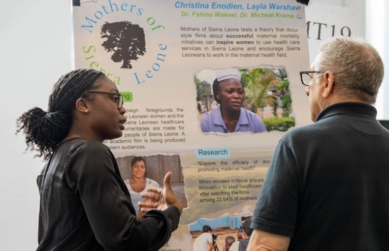 Young woman presenting her research project at the Mountaintop Research Expo